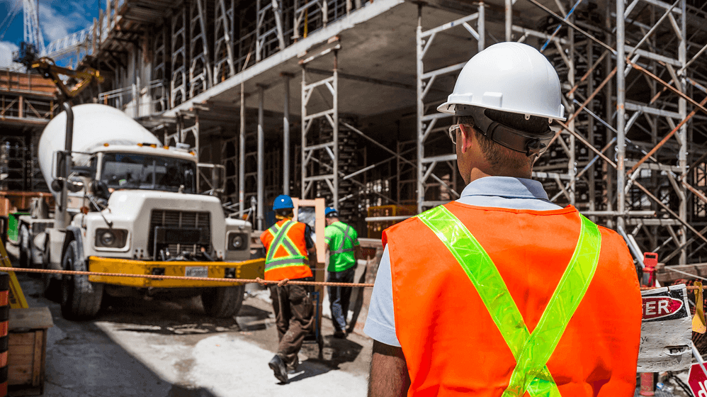 Man on his back wearing safety gear on site