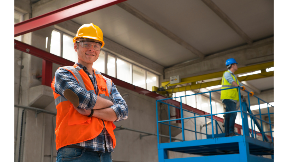 Worker on scissor lift in warehouse